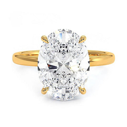 Gold ring with a large oval-shaped diamond on a white background